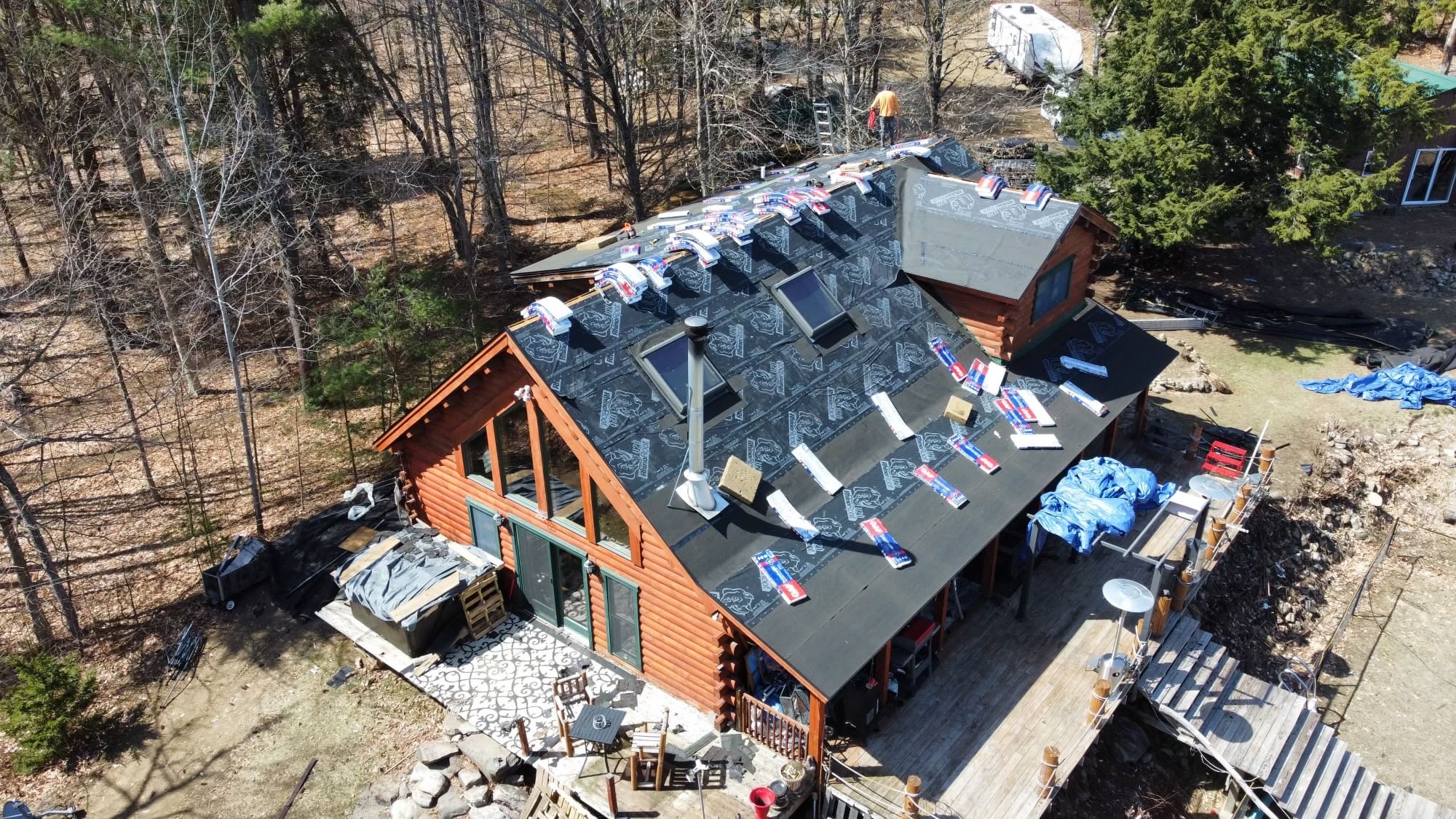 aerial view of Roof replacement in progress on a residential cabin