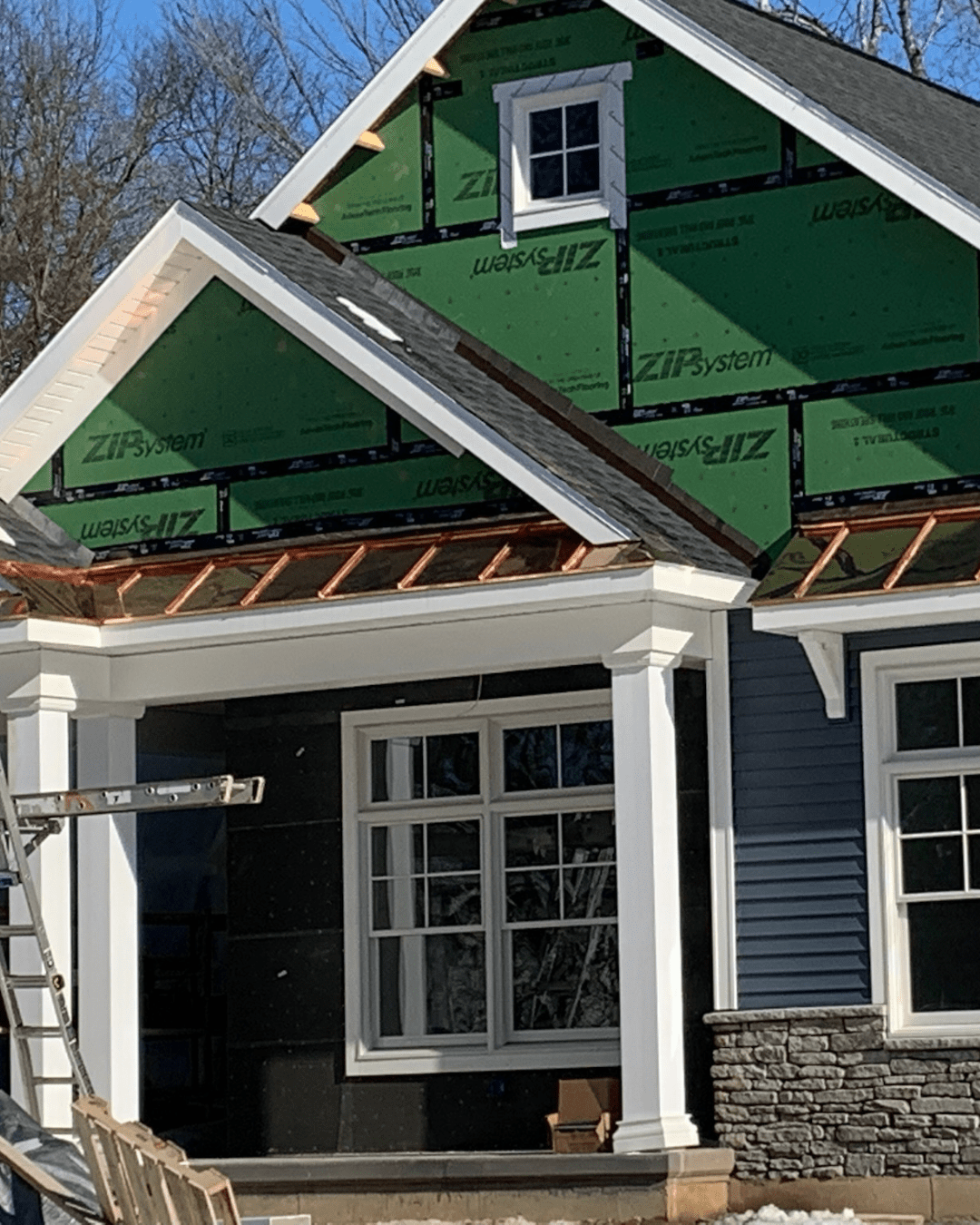 New build residential home with copper roofing on the awnings