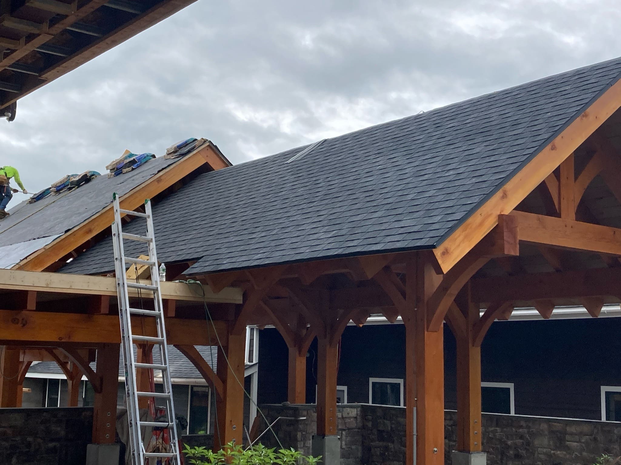 Asphalt shingles on walkway roof of commercial building