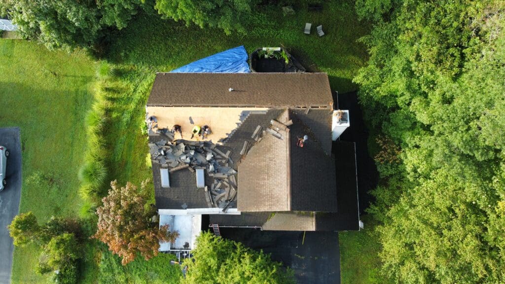 Aerial view of home with roof damage about to be getting a full roof replacement by KC Entities Roofing and Siding