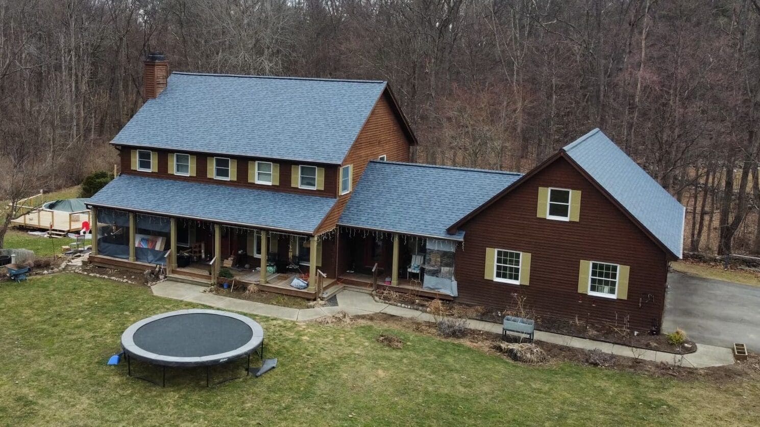 Complex roof system on residential home with Owens Corning Harbor Blue asphalt shingles replaced by KC Entities Roofing and Siding