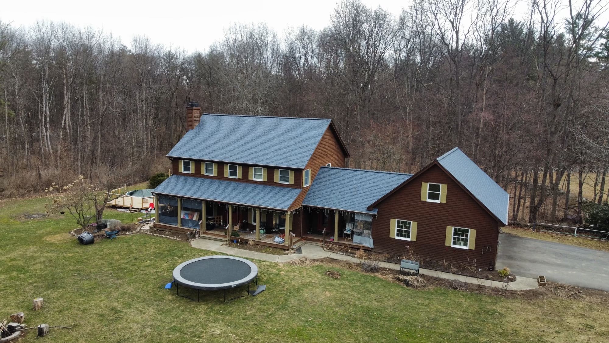 Complex roof system on residential home with Owens Corning Harbor Blue asphalt shingles replaced by KC Entities Roofing and Siding