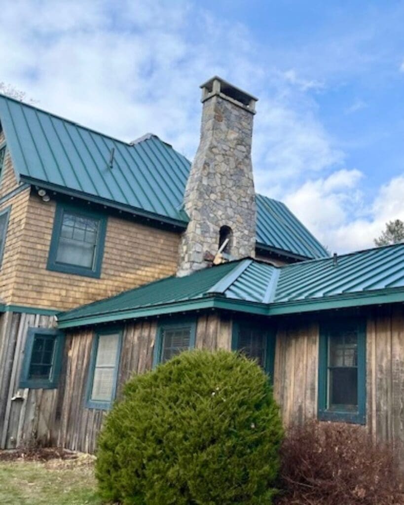 Residential home with green standing seam metal roofing