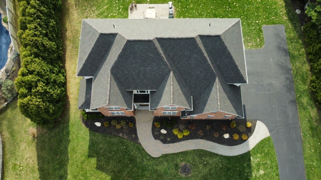 birds-eye view of a residential house showing that the roof has just been replaced and now has GAF Midnight Mesa asphalt shingles