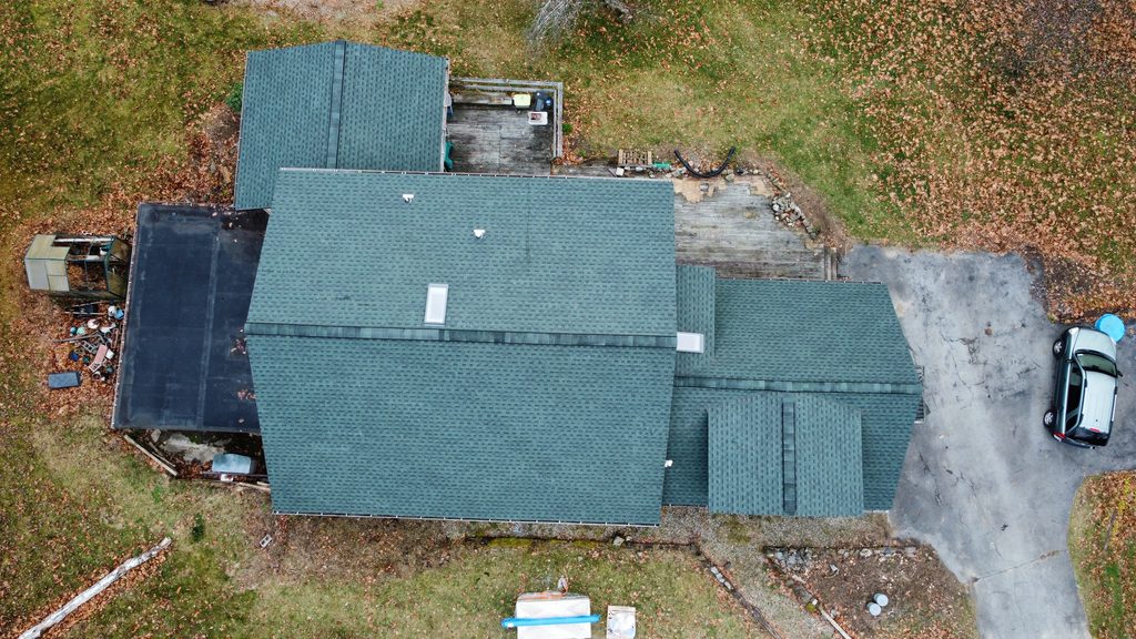 Home with roof replacement completed by KC Entities Roofing and Siding with GAF Hunter Green asphalt shingles