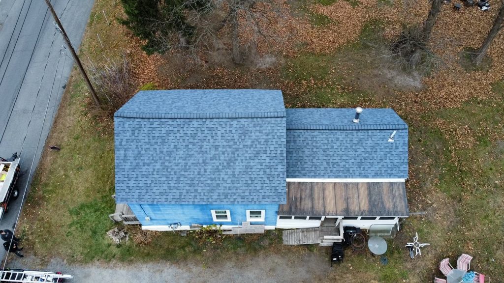 Home with roof replacement completed by KC Entities Roofing and Siding with Owens Corning Harbor Blue asphalt shingles