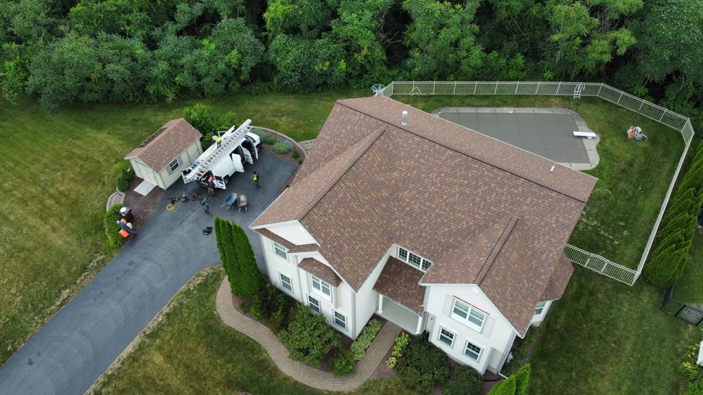 Home with roof replacement completed by KC Entities Roofing and Siding with Owens Corning Desert Rose asphalt shingles